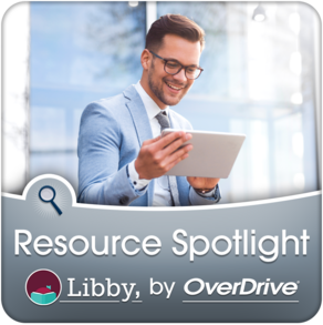 A businessman is reading an iPad outdoors