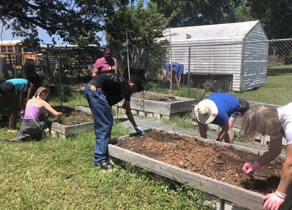 Students gardening at Club Esteem
