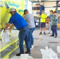 City of Melbourne employees demonstrate an automated sandbagger