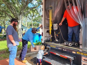 Toddler looking at camera truck with Stormwater staff