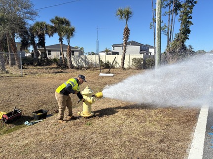 staff flushing out fire hydrant