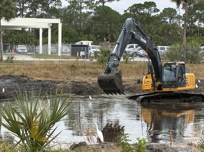 Excavator cleaning out pond