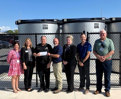 Representatives from City of Melbourne, FPL and Trane standing in front of chillers at the Joseph Pellicano Law Enforcement Center