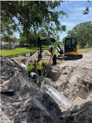 Photo of workers installing a storm pipe 