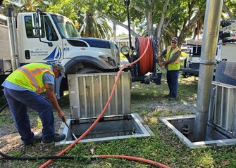 Public Works staff cleaning out baffle boxes