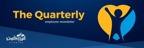 Blue background with yellow and light blue heart and city logo. Text reads 'The Quarterly employee newsletter'