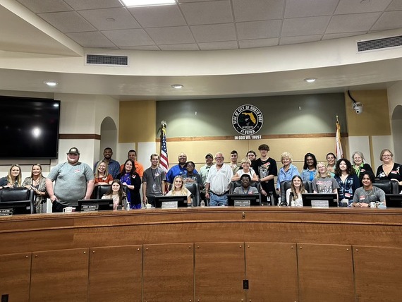  Students and staff standing on dias