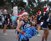 A cheerleader marches in the Poinsettia Parade and Festival in North Port