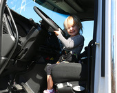 A child checks out a Solid Waste truck at the Road-E-O