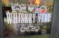 Whiskey Neat's door and logo