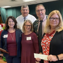 friends of the library giving check to library director