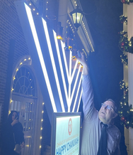 mayor sortal lighting the menorah at city hall