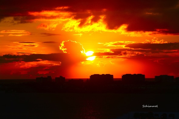 Schimmel - orange sunset bursting through clouds - 2025