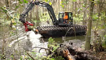 Heavy equipment clearing river