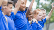 Summer camp kids standing in line cheering