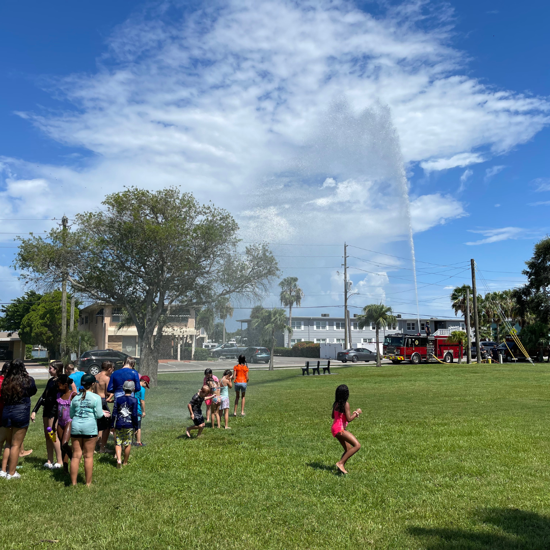 Treasure Island Fire Rescue Summer Camp Splash Down. Kids getting sprayed by hose.