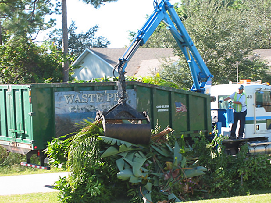 Picure of a claw truck picking up debris