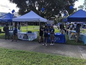 Treasure Bay Golf and Tennis with a table at St Petersburg College Anniversary party with tennis raquets lined up in front