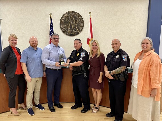 Treasure Island Police officers pose with City Commissioners with award
