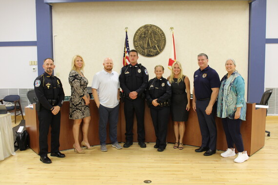 City Commission poses with two new TIPD officers
