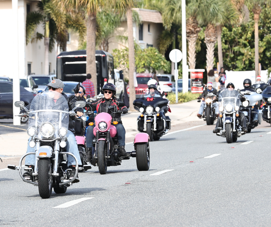 Motorcyles ride in line along road 