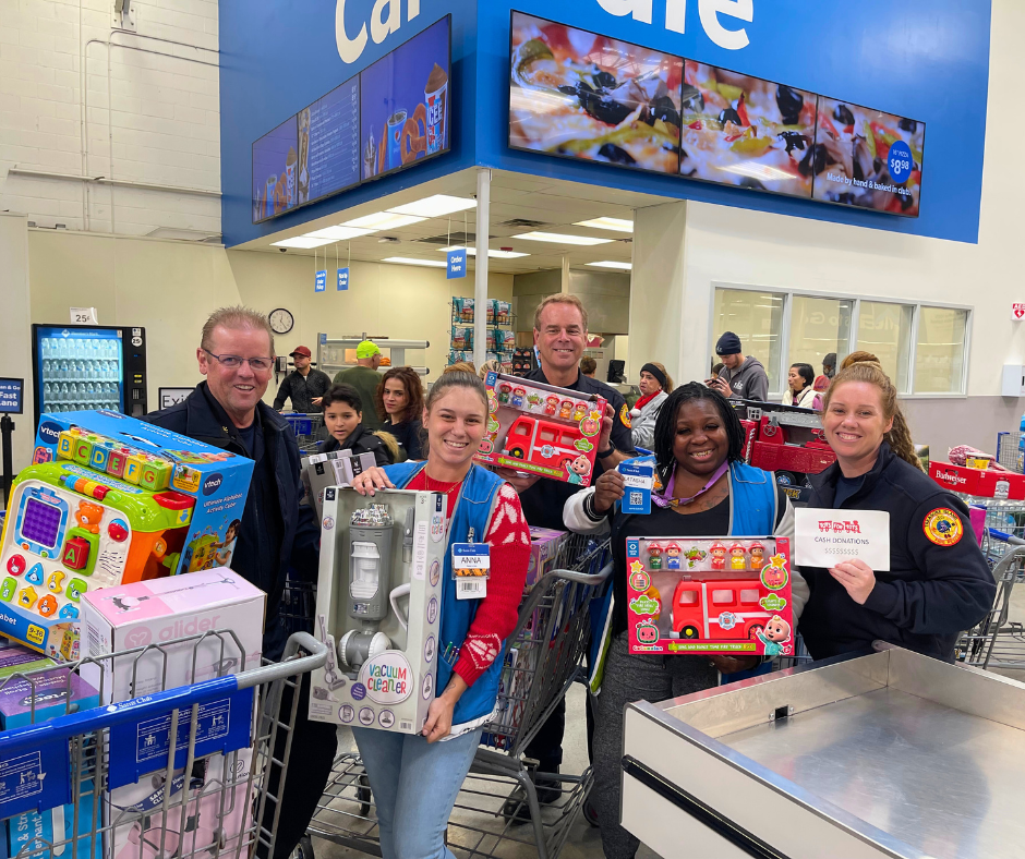 Treasure Island Fire Rescue posting with Sams Club employees while shopping for toys