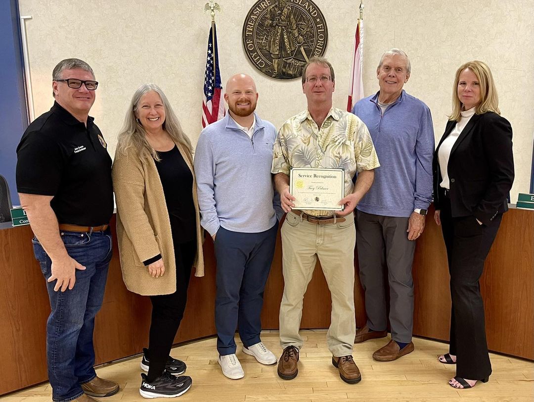 Troy Palmer pictures with City Commissioners and his 30 years of service certificate