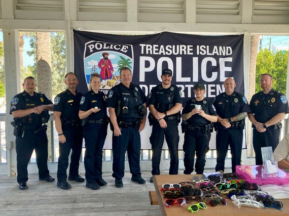 TIPD officers pose for a picture in front of police banner