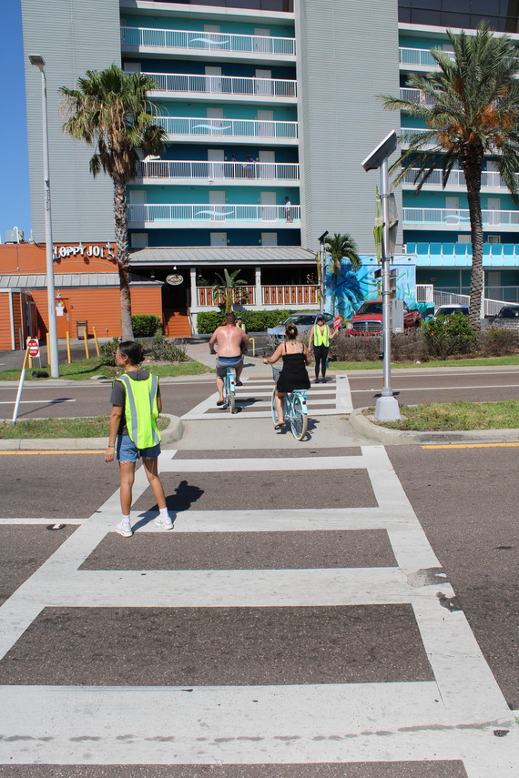 Volunteers helping people cross the road