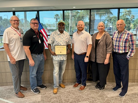 City employee Brian Harris with 20 year of service award and City Commission