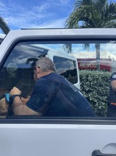 Treasure Island Fire Rescue member getting a dog out of a locked vehicle