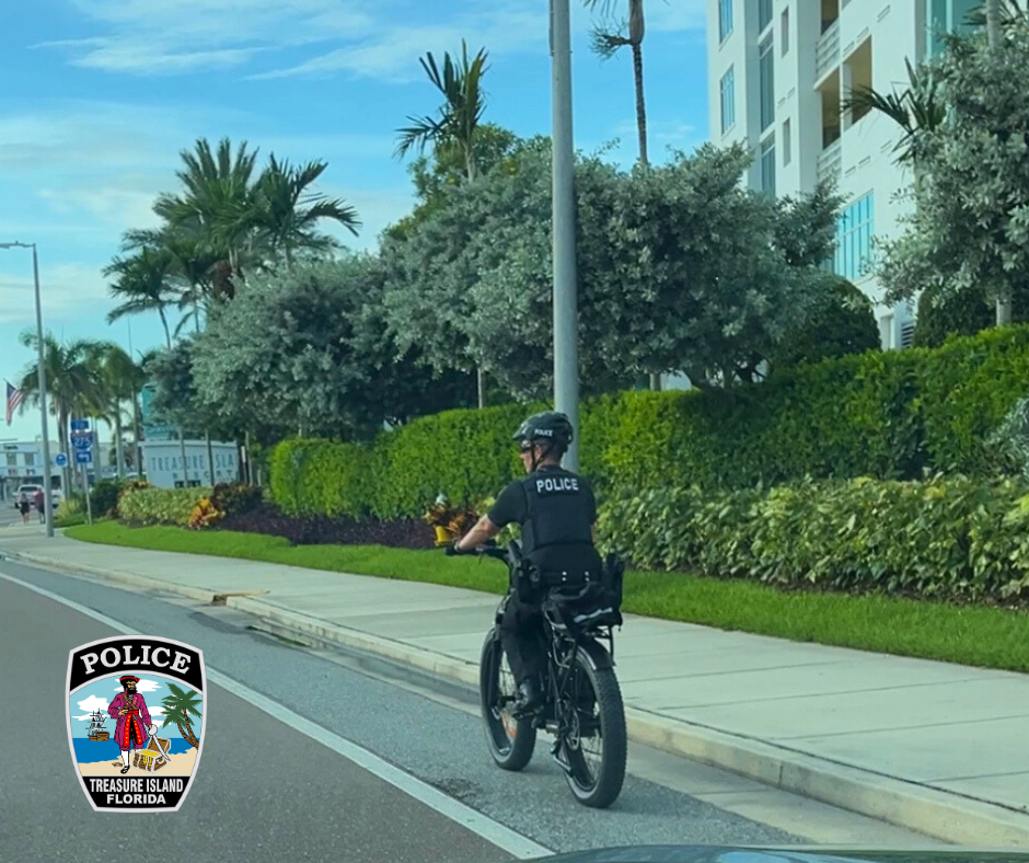 TIPD offcier Funck on bike patrol along a roadway