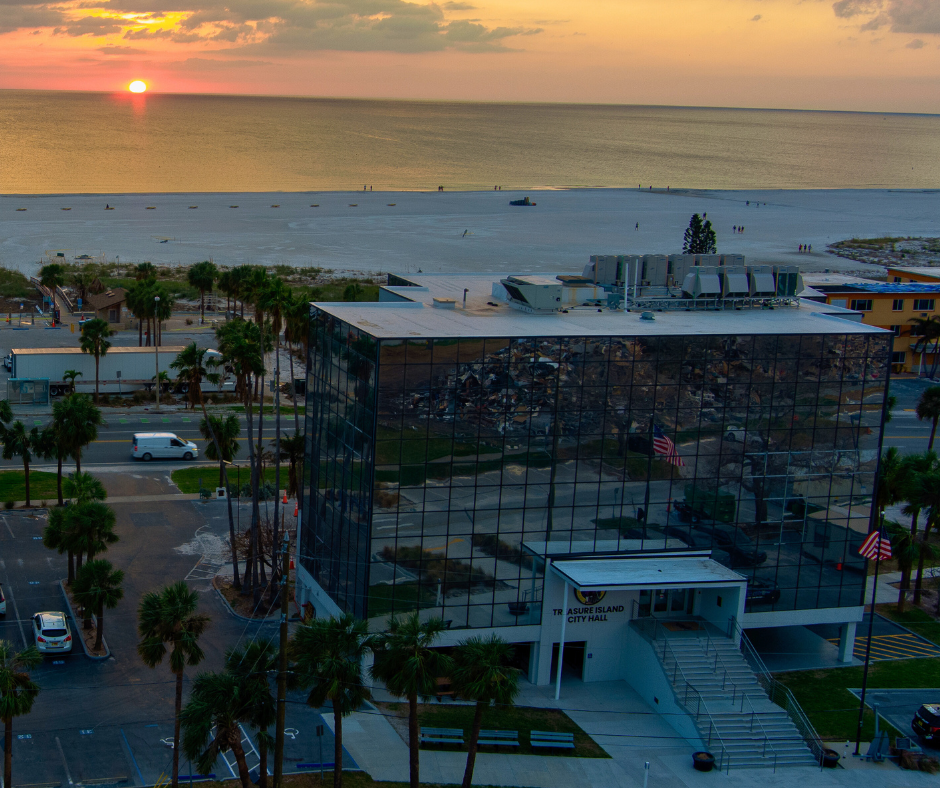 Wide aerial of City Hall with sunset in background
