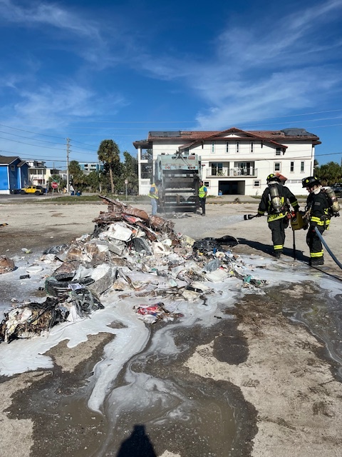 Treasure Island Fire fighters battling a fire in a city trash truck