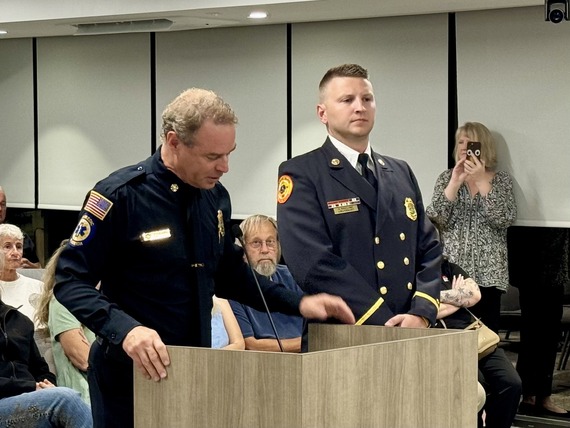 Treasure Island Fire Rescue Lieutenant Rowland with Chief Barrs at podium at Commission meeting