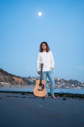 Singer Doug Smith posing with guitar