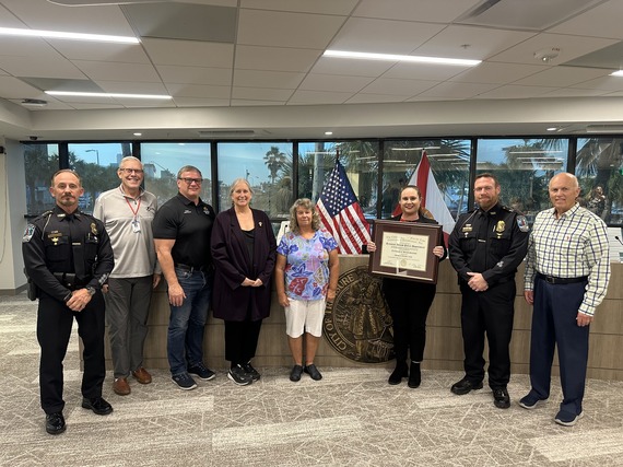 Treasure Island Police Department personnel posing with accreditation award with city commission