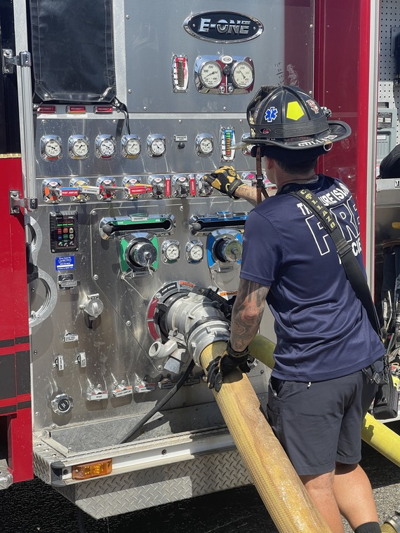 Treasure Island Fire Rescue member working the hose on a fire engine