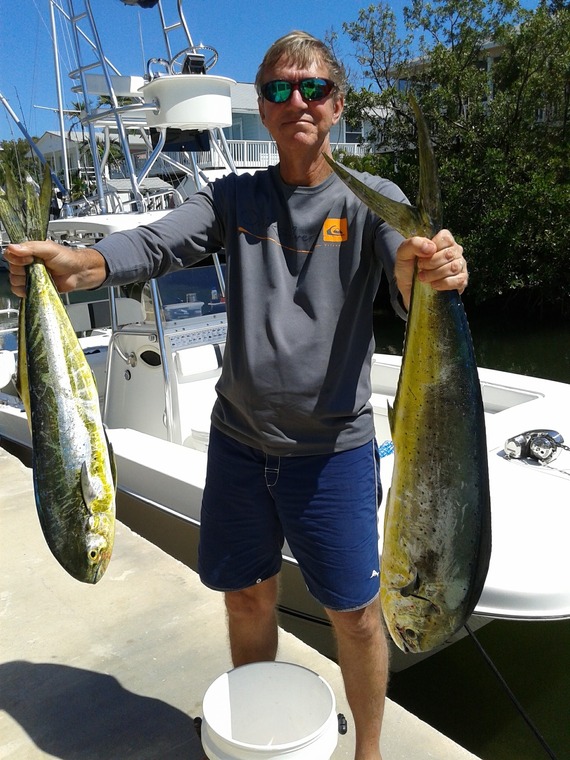 Gary Volenec holding up fish he caught