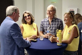 New City Manager Charles Van Zant chatting with residents at a table