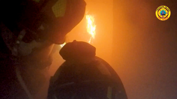 Fire department doing live fire training in a burning building