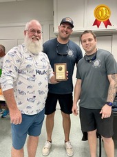 Treasure Island Fire Rescue members posing with winner of the Chili Cook-Off