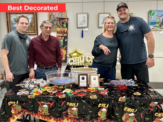 Treasure Island Fire Rescue members posing with winner of best decorated table at the Chili Cook-Off
