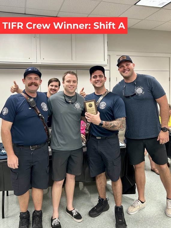 Treasure Island Fire Rescue members posing with winners of Chili Cook-Off
