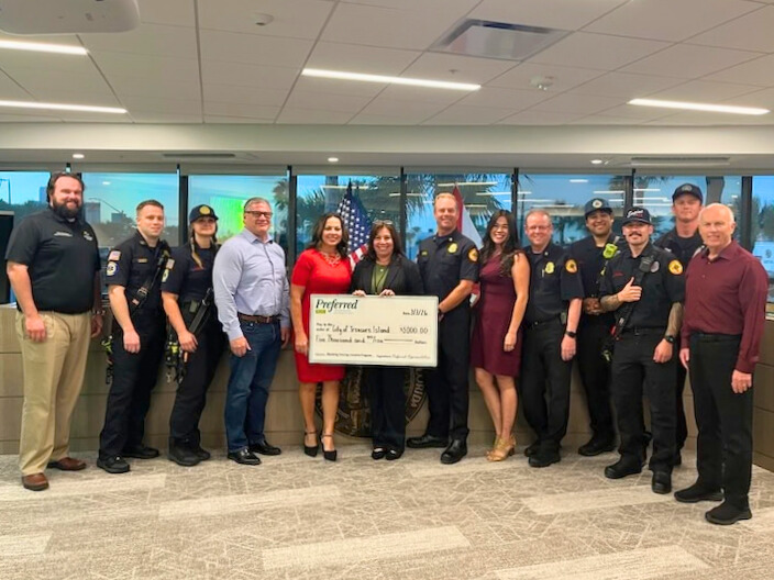City commission posing with check