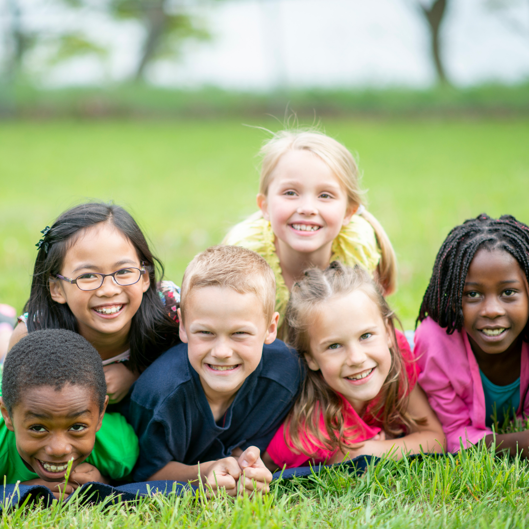 Summer camp kids in a pile posing for a picture