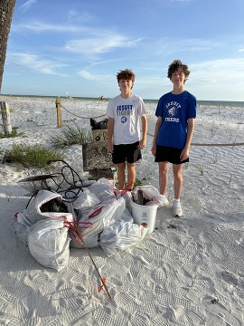 Connor pictured with some volunteers at Connor's Neighborhood Cleanup