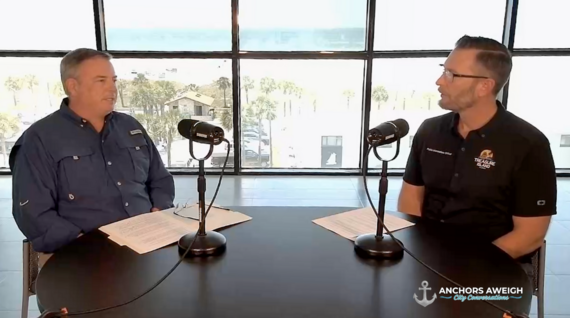 Two shot of City Manager and Public Information Officer at a table doing a podcast