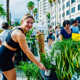 GreenMarket Woman holding Plants