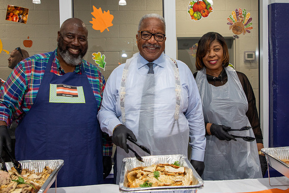 Mayor James and two others smile for a photo while serving food during Share-a-Supper